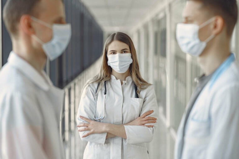 Doctors wear masks talking